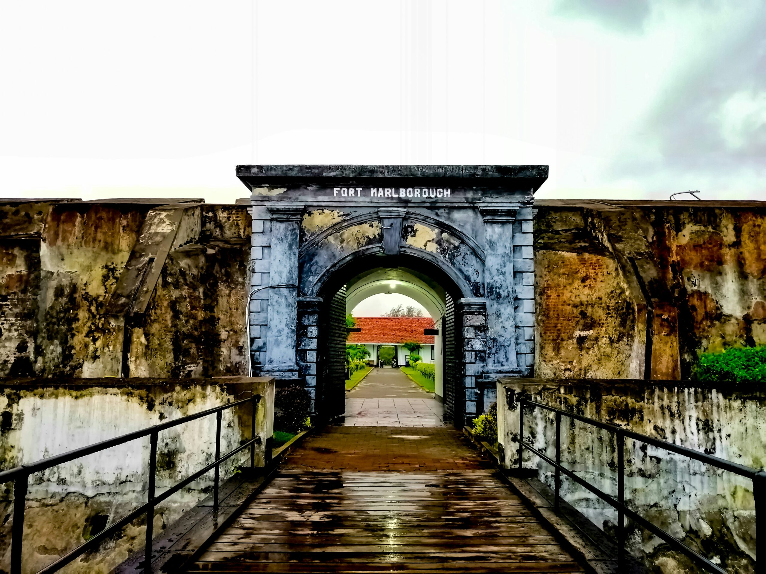 concrete archway under a white sky